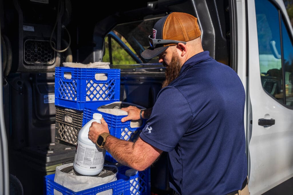 serclean technician grabbing sanitizing solutions for mold removal in lawrenceville
