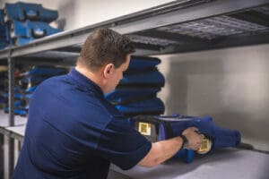 serclean technician grabbing dehumidifier and fan for water damage restoration