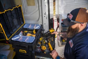 serclean technician grabbing tools from back of a Serclean van.