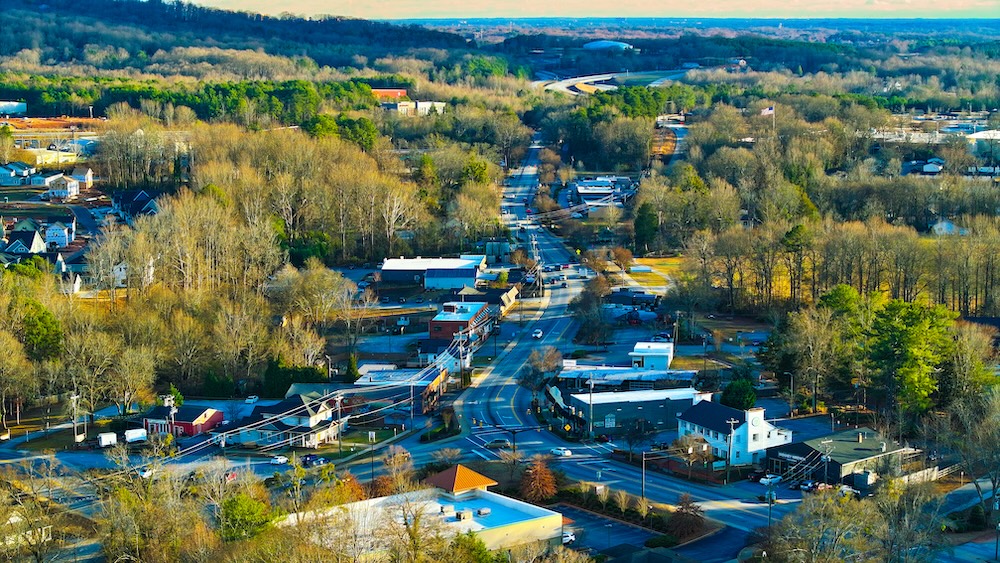 Ariel city view in residential area with forest backdrop