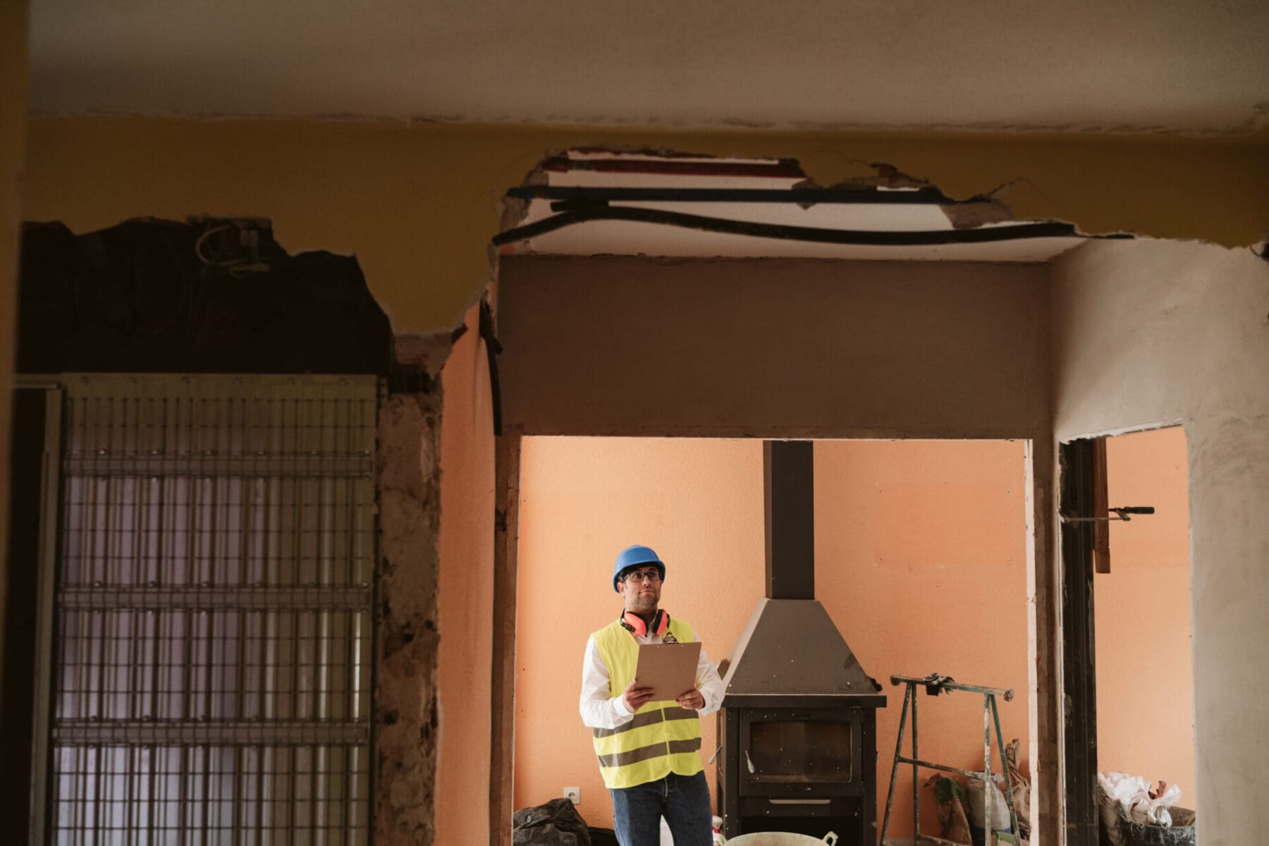 Technician inspecting fire-damaged home for safety and structural stability